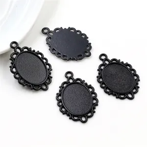 Set of four vintage matte black oval pendant bases with hollow lace edges on white background