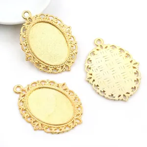 Macro view of gold alloy oval pendant base with intricate filigree lace detailing
