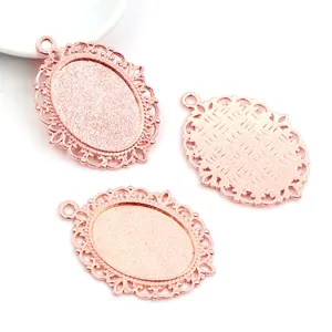 Detailed view of rose gold oval alloy pendant bases with vintage filigree for DIY jewelry