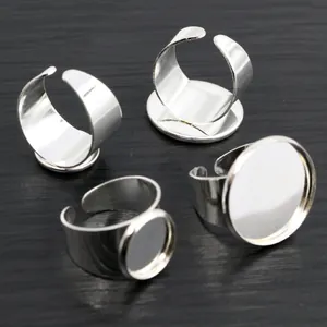 Macro view of adjustable silver ring blanks with flat round trays for DIY jewelry making