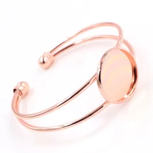 Detailed macro view of the rose gold open bangle with a round blank cabochon bezel setting
