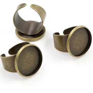Three bronze adjustable rings with round base settings for DIY jewelry making on white