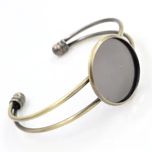 Detail of vintage bronze cuff bracelet base with double-wire design and round bezel setting