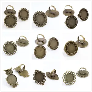 Nine vintage bronze adjustable ring blanks with ornate filigree and owl design settings