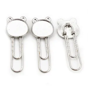 Detailed view of silver bear-shaped metal bookmark paperclips for DIY jewelry making