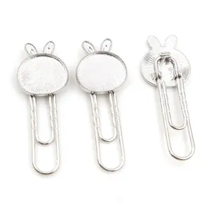 Macro detail of silver bunny paperclips with DIY gem trays for jewelry making and bookmarks