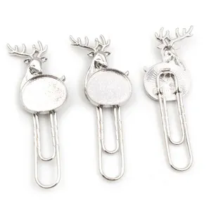 Detailed view of silver deer head paper clips with DIY jewelry bezel trays in a set of three
