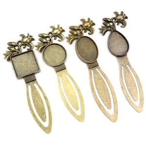 Set of four vintage bronze alloy bookmarks with floral embossed trays for DIY jewelry craft