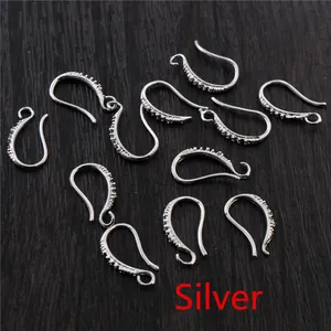 Silver plated 17x10mm DIY earwire hooks with micro-pave crystals on wooden background