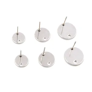 Flat lay of silver stainless steel round stud earring posts with holes for DIY jewelry