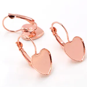 Macro view of rose gold heart-shaped leverback earring findings with serrated edges