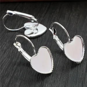 Silver 12mm heart lever-back earring hooks for DIY jewelry making on wood background