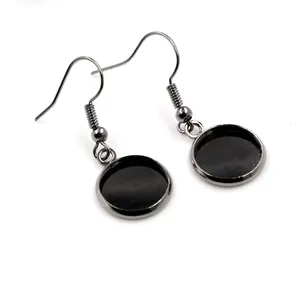 Macro detail of gunmetal earring hooks with round blank base trays for DIY jewelry making