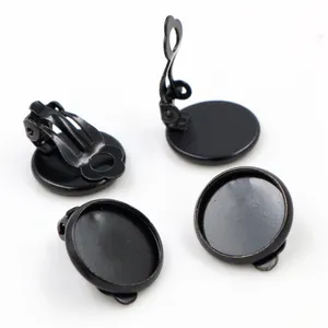Macro view showing four black metal DIY ear clip bases with round tray and hinge mechanism