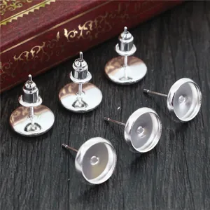 Macro shot of silver round stud earring blanks with backs for DIY jewelry making