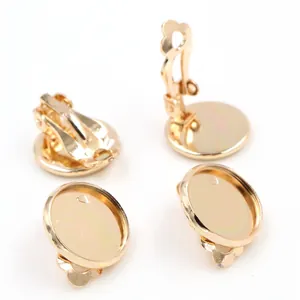 Macro detail of golden DIY clip-on earring bases with round tray for jewelry making