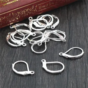 Silver lever back earring hooks displayed on a rustic background for DIY jewelry making