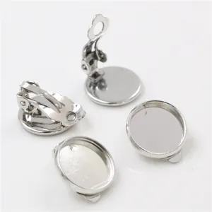 Macro detail of polished silver round tray clip-on earring bases for DIY jewelry making
