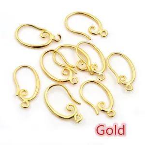 Macro detail of French gold-plated copper fishhook ear wires with spiral coil for DIY