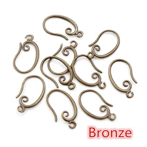 Detail of bronze DIY earring hooks with scroll patterns for jewelry making