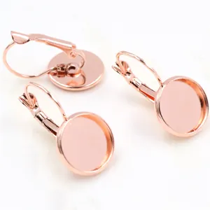 Macro detail of rose gold lever-back earring settings with round trays for DIY jewelry making