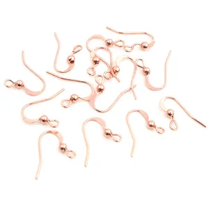 Detailed view of rose gold earring hooks with decorative beads for DIY jewelry making