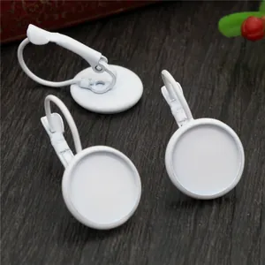 Macro shot of white matte 12mm lever back earring trays for DIY jewelry making