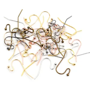 Pile of S-shaped fishhook earwires with decorative beads in diverse metallic finishes