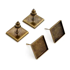 Close-up of 12mm antique bronze square tray stud earring settings for DIY jewelry