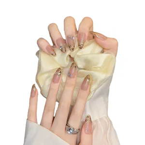 Press-on nails featuring leopard print, golden lines, and small butterfly rhinestone accents