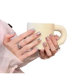 Handmade light purple gradient press-on nails with golden butterfly and rhinestone accents