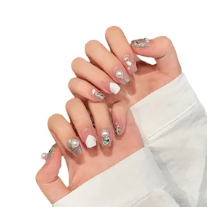French style press-on nails with pearls, rhinestones, and silver glitter on square-oval tips
