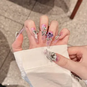 Handmade long ballet press-on nails with purple glitter, metal bows and rhinestones