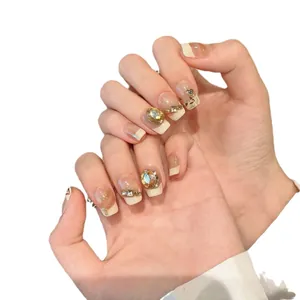 Champagne amber ombre press-on nails with luxury rhinestones and gold leaf decor
