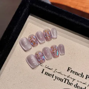 Handmade lavender cat eye press-on nails with purple shimmer and glitter accents