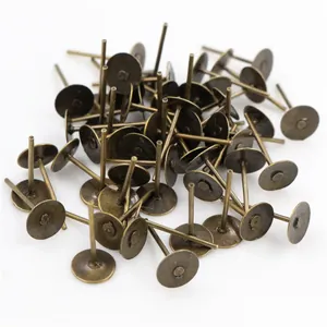 Macro detail of bulk antique bronze flat pad ear studs for DIY jewelry making