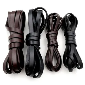 Close-up of flat black and dark brown genuine leather cords for DIY handmade jewelry