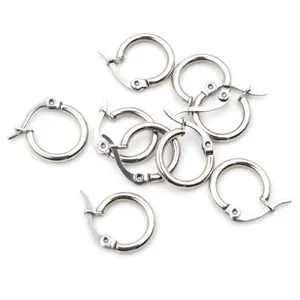 Close-up of small silver stainless steel leverback hoop earrings on white background
