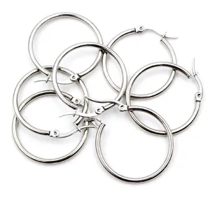Set of multiple silver stainless steel hoop earrings with polished metal finish