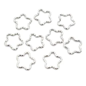 Detailed view of silver star shaped textured metal jump rings for DIY jewelry making