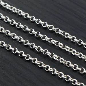 Macro shot of silver plated iron O-chains for DIY jewelry making on dark wood background