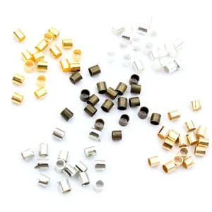 Macro view of assorted metal crimp beads in gold, silver and bronze for DIY jewelry