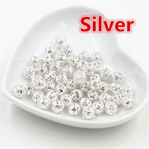 Detailed macro view of 4-10mm silver hollow filigree round beads for DIY jewelry making