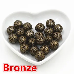 Macro view of bronze hollow filigree metal beads for DIY jewelry making crafts