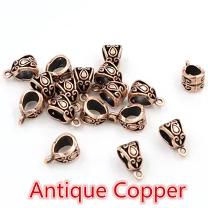 Macro shot of antique copper alloy pendant bails with retro floral engraving for jewelry DIY