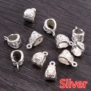 Macro view of silver alloy bail beads with intricate floral engraving for DIY jewelry