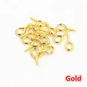Detailed close-up of golden screw eye pins for DIY jewelry making and pearl pendants
