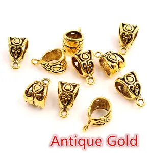 Macro view of antique gold alloy bail beads with embossed patterns for DIY jewelry