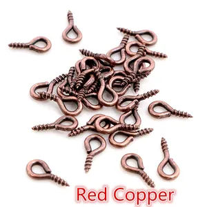 Detailed view of red copper screw eye pins for DIY jewelry making and pendants