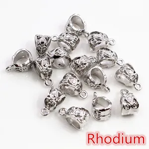 Macro detail of alloy bail bead connectors with hollow flower pattern in rhodium finish